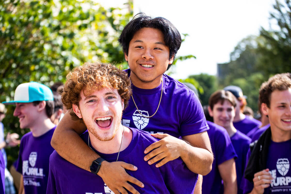 Students give each other piggyback rides during March Through the Arches for the Class of 2026 on September 6, 2022, in St. Paul.