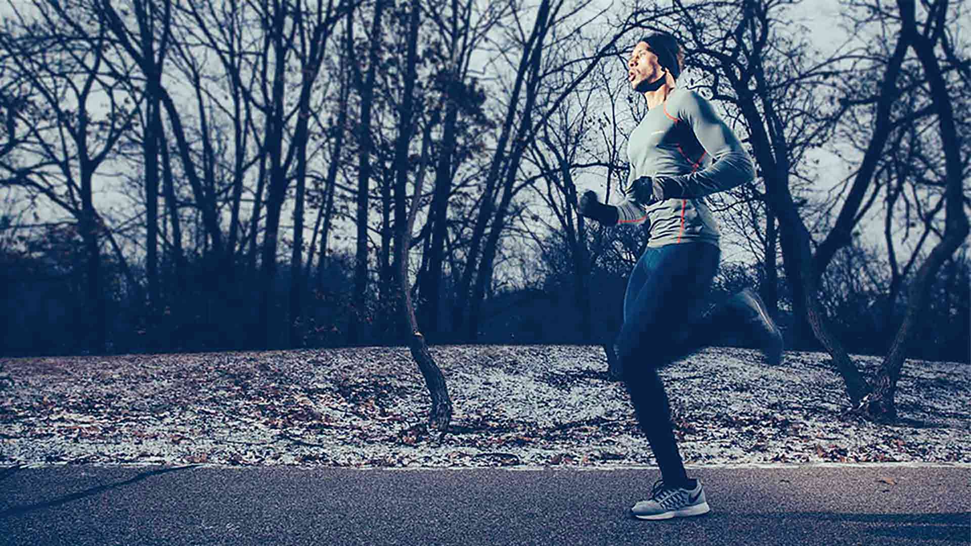 Student runs on a path along the Mississippi River